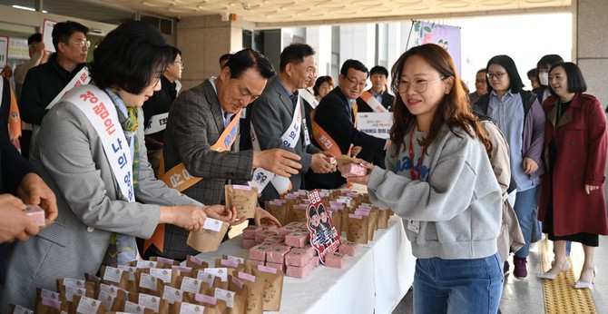 백성현 시장이 4일 출근길 직원들에게 딸기떡과 '딸기씨 가든백'을 주고 있다. ⓒ 논산시
