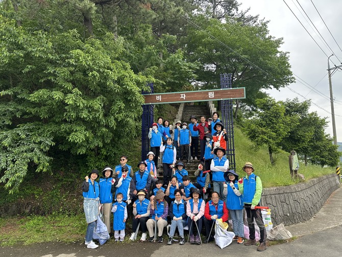남해군자원봉사센터가 남해바다정원에서 비자림에 이르는 구간에서 환경 정화 활동과 멸종위기 식물 관찰을 결합한 '금자란 찾는 줍깅' 자원봉사활동을 펼치고 기념촬영을 하고 있다. ⓒ 남해군
